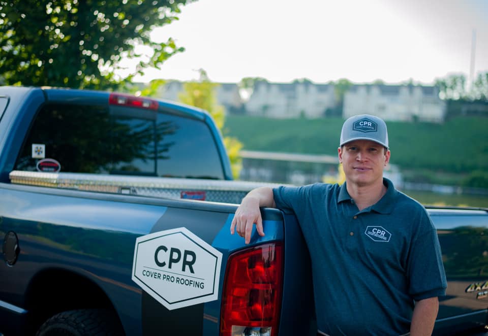 Man standing near a car_Cover Pro Roofing