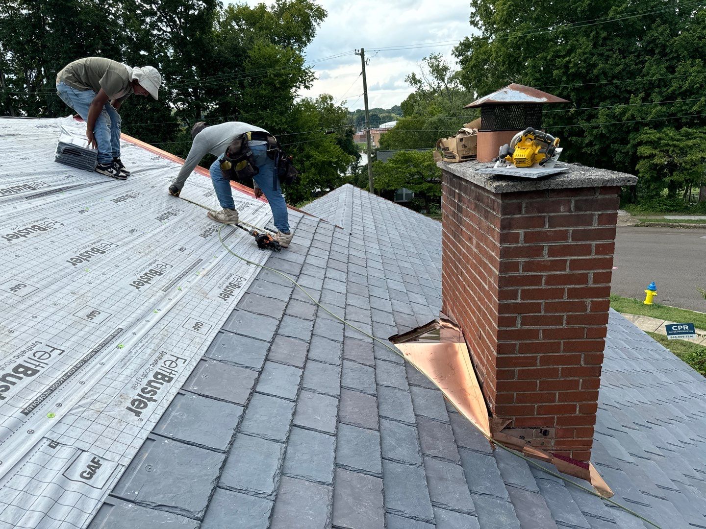 man taking size of the roof_Cover pro roofing