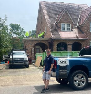 Cover pro roofing Professional standing by cover pro roofing service van