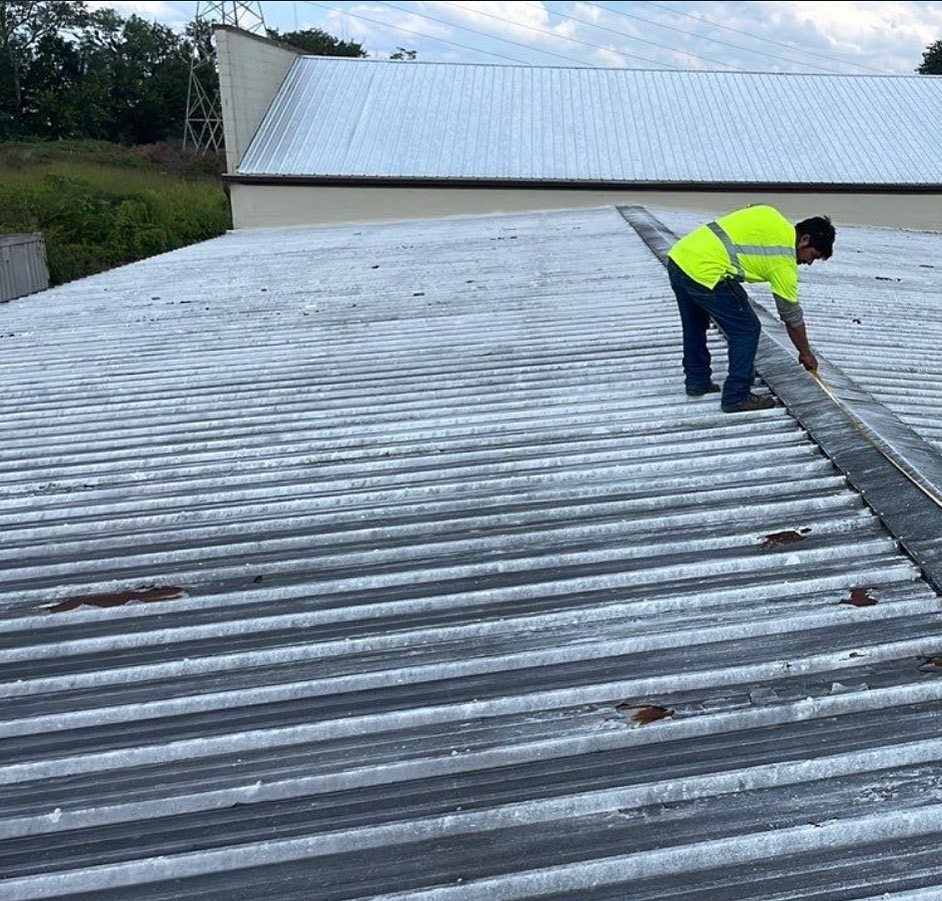 Man working on metal roofing 